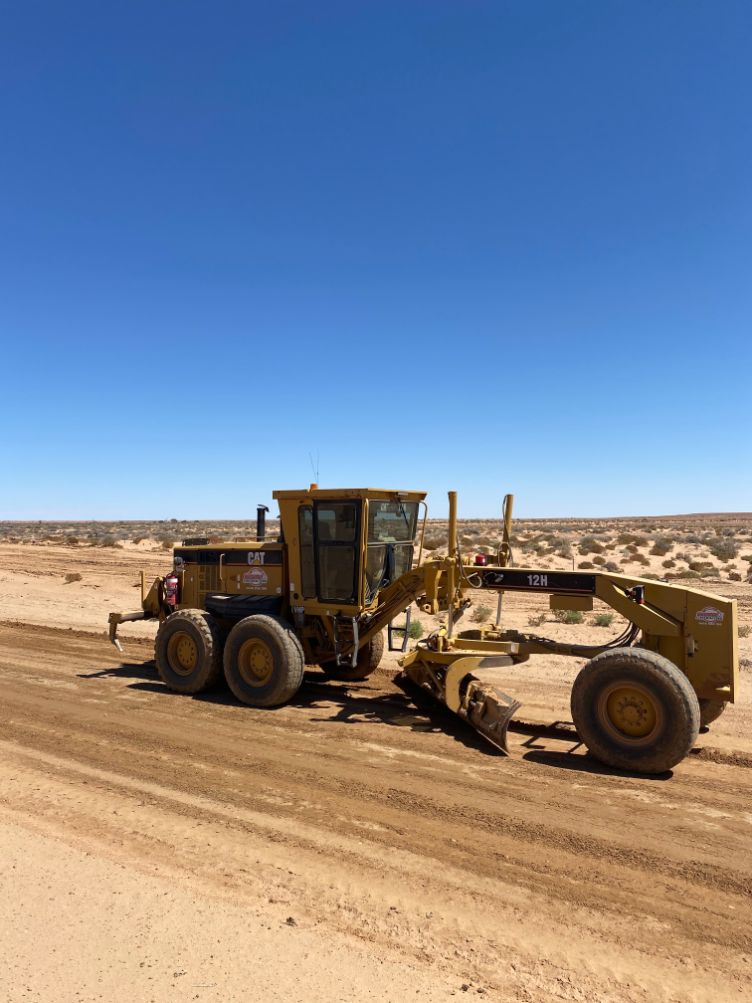 An Excavator performing road construction services